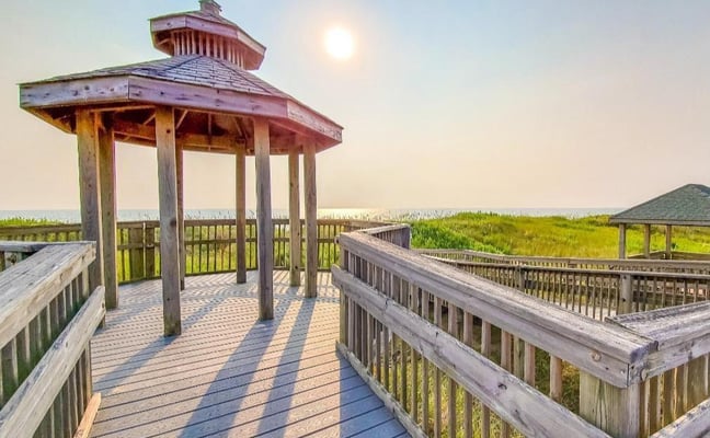 Dune top gazebo with the sunrise in the background in Corolla.